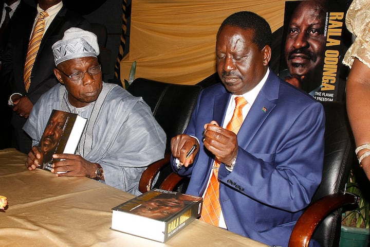 Raila Odinga and Olusegun during the launch of Odinga's autobiography - The Flame of Freedom at the KICC in Nairobi, Kenya